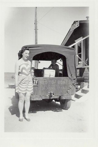1949: WWII surplus Jeep (named Jule) parked next to the original boat house. Cousin Ivy with Ralphs brother, Bill, inside holding a bushel basket.